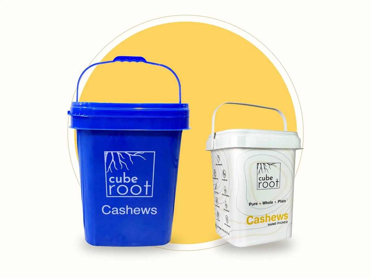Cube Root 10kg bulk cashew bucket beside a 1kg cashew container